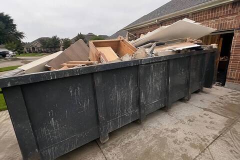 Dumpster filled with remodeling debris