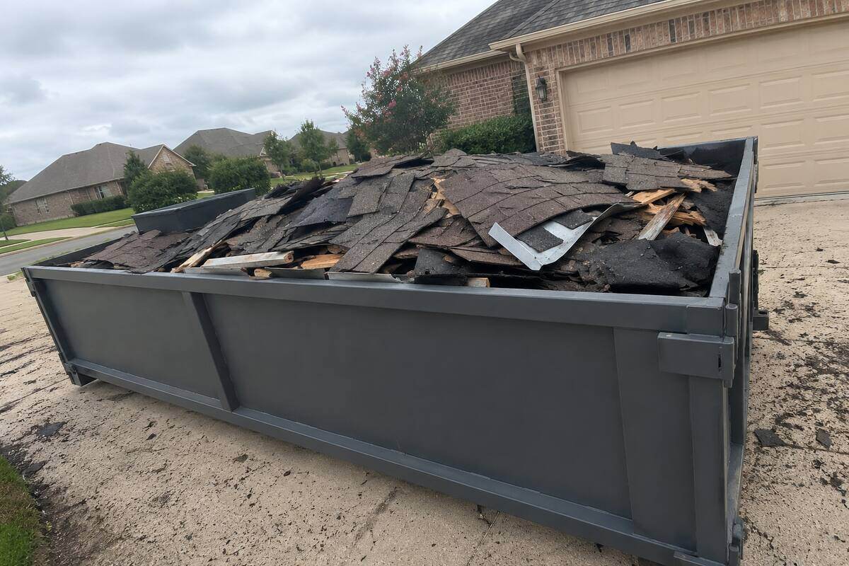 Dumpster loaded with roofing tear-off
